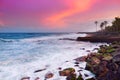 Beautiful pink tinted waves breaking on a rocky beach at sunrise on east coast of Big Island of Hawaii Royalty Free Stock Photo