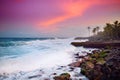 Beautiful pink tinted waves breaking on a rocky beach at sunrise on east coast of Big Island of Hawaii Royalty Free Stock Photo