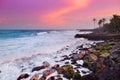 Beautiful pink tinted waves breaking on a rocky beach at sunrise on east coast of Big Island of Hawaii Royalty Free Stock Photo