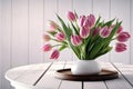 Beautiful pink tulip flower bouquet on white wooden table. Mother\'s day concept. View with copy space. Image is AI generated Royalty Free Stock Photo