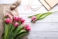 Beautiful pink tulips with paper, linen string and shopping bag