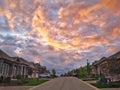 Beautiful pink yellow red dramatic sky clouds in Alliston town, Ontario, Canada. Landscape scene with residential area road and Royalty Free Stock Photo
