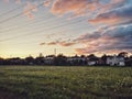Beautiful pink yellow red purple evening sky clouds in Toronto city, Canada. Landscape scene view with residential area road and Royalty Free Stock Photo