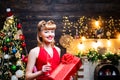 Beautiful pinup girl with Christmas holiday pin-up makeup holding glass of champagne. Happy retro woman celebrate Merry Royalty Free Stock Photo