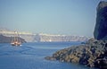 Summer scene with volcanic island Santorini with caldera, rocks and a tourist ship