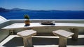 Beautiful place in Oia with a table and chairs for romantic meetings - great view of the bright blue sea Royalty Free Stock Photo