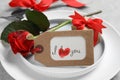 Beautiful place setting with gift box and flower on table, closeup. Valentine`s day romantic dinner Royalty Free Stock Photo
