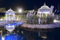 Beautiful place with two gazebos and wooden bridge over water with night lighting. North Cyprus landscape Royalty Free Stock Photo