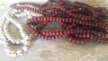 Beautiful plastic prayer beads or rosary placed over concrete background