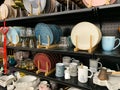 Beautiful plates and glasses, on the shelf of the store.