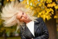 Beautiful playful woman with long blonde hair in autumn park Royalty Free Stock Photo