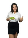 Beautiful plus size Asian woman holding a bowl of salad and showing thumb up