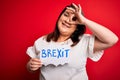 Beautiful plus size woman holding brexit banner for political referendum in europe with happy face smiling doing ok sign with hand Royalty Free Stock Photo