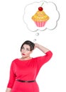 Beautiful plus size woman thinking about cake Royalty Free Stock Photo