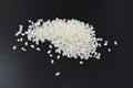 Beautiful polished loose white round rice on a black background, rice grains