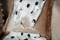 A beautiful polka-dot nightgown is lying on the sofa. selective focus with a small focus area