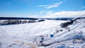 Beautiful ponamara in the winter. The river is covered with ice and snow. Winter landscape. Clear blue sky with clouds Royalty Free Stock Photo