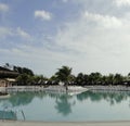 Beautiful pool on Cumbuco beach at evening with palm trees in the background Royalty Free Stock Photo