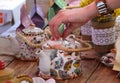 Beautiful porcelain teapots with painting and female hand close-up