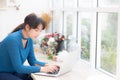 Beautiful portrait asian young woman working online on laptop sitting at cafe shop Royalty Free Stock Photo