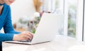 Beautiful portrait asia young woman working online on laptop sitting at cafe shop, professional female freelance using notebook Royalty Free Stock Photo