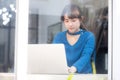 Beautiful portrait asia young woman working online on laptop sitting at cafe shop, professional female freelance using notebook Royalty Free Stock Photo