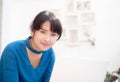 Beautiful portrait asia young woman working online on laptop sitting at cafe shop Royalty Free Stock Photo