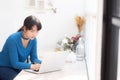 Beautiful portrait asia young woman working online on laptop sitting at cafe shop Royalty Free Stock Photo