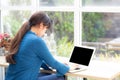 Beautiful portrait asia young woman working online on laptop sitting at cafe shop, professional female freelance using notebook Royalty Free Stock Photo