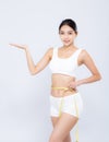 Beautiful portrait asian woman diet and slim with measuring waist for weight presenting something on hand isolated Royalty Free Stock Photo