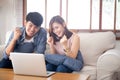 Beautiful portrait asian young couple working laptop with smile and happy sitting on couch at living room