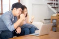 Beautiful portrait asian young couple working laptop with smile and happy sitting on couch at living room Royalty Free Stock Photo