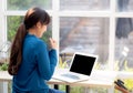 Beautiful portrait asian young freelance woman working online laptop with smile and happy at cafe shop Royalty Free Stock Photo