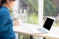 Beautiful portrait asian young freelance woman working online laptop with smile and happy at cafe shop Royalty Free Stock Photo