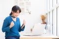 Beautiful portrait asian young freelance woman working online laptop with smile and happy sitting at cafe shop Royalty Free Stock Photo