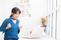 Beautiful portrait asian young freelance woman working online laptop with smile and happy sitting at cafe shop Royalty Free Stock Photo