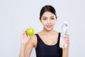 Beautiful portrait asian young woman bottle of water and green apple for healthy isolated on white background Royalty Free Stock Photo