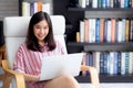 Beautiful of portrait asian young woman freelance working online laptop sitting on chair at living room