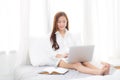 Beautiful of portrait asian young woman setting on bed using laptop computer and notebook at bedroom for leisure and relax Royalty Free Stock Photo