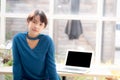 Beautiful of portrait asian young woman sitting looking camera and laptop on table at coffee shop Royalty Free Stock Photo