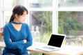 Beautiful of portrait asian young woman sitting looking camera and laptop on table at coffee shop Royalty Free Stock Photo