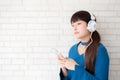 Beautiful portrait asian young woman standing happy enjoy and fun listen music with headphone Royalty Free Stock Photo