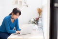 Beautiful portrait asian young woman working online on laptop sitting at cafe shop Royalty Free Stock Photo
