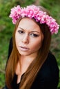 Beautiful portrait of a blonde girl with a pink crown of flowers