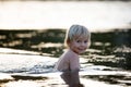 Beautiful portrait of child in lake, kid playing