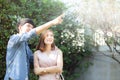 Beautiful portrait couple looking each others eyes and smiling with happy, young asian man and woman relation pointing something Royalty Free Stock Photo