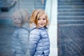 Beautiful portrait of cute little toddler girl. Happy baby child looking at the camera and smiling. With reflections of Royalty Free Stock Photo