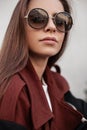 Beautiful portrait female face. Attractive young woman hipster with long hair with sexy lips in stylish sunglasses in fashion Royalty Free Stock Photo