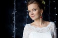 Beautiful portrait of a gentle cute happy bride in a white dress with a bright little colored bouquet