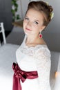 Beautiful portrait of a gentle cute happy bride in a white dress with a bright little colored bouquet Royalty Free Stock Photo